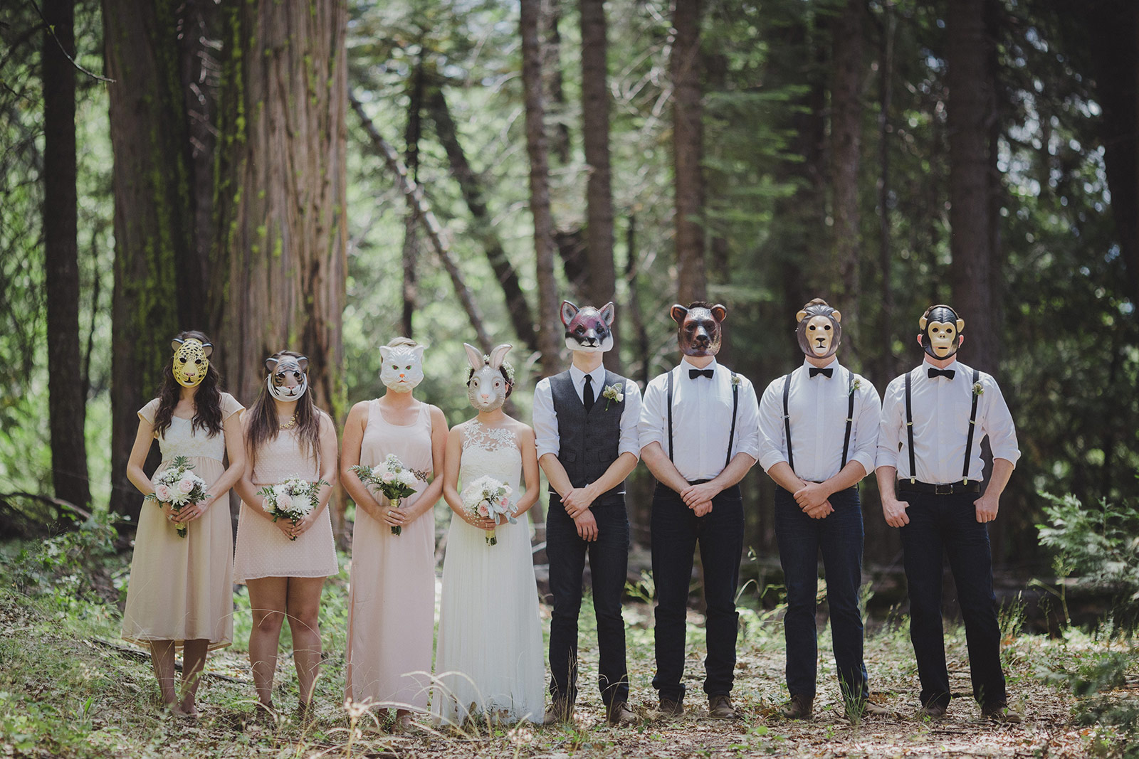 A group of people wearing masks in the woods.