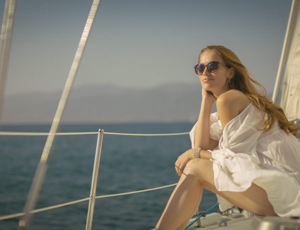 A woman sitting on the deck of a boat.